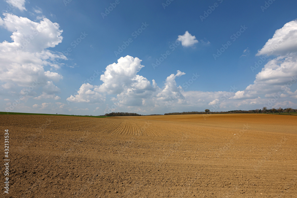 Spring landscape with arable land and meadows Spring landscape with arable land and meadows
