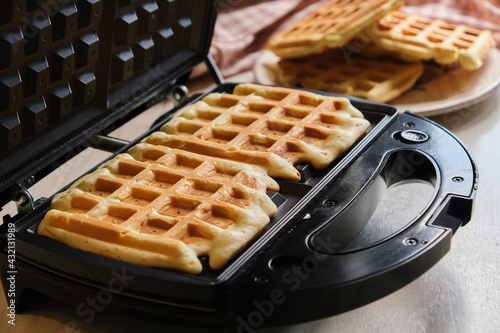 Obraz na plátne waffles are baked waffle iron machine. close up