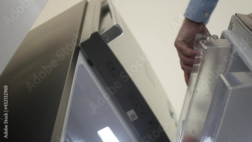 Thirsty Person Opens Door Fridge, Takes a Bottle with Fresh Cold Water and Closes the Door.