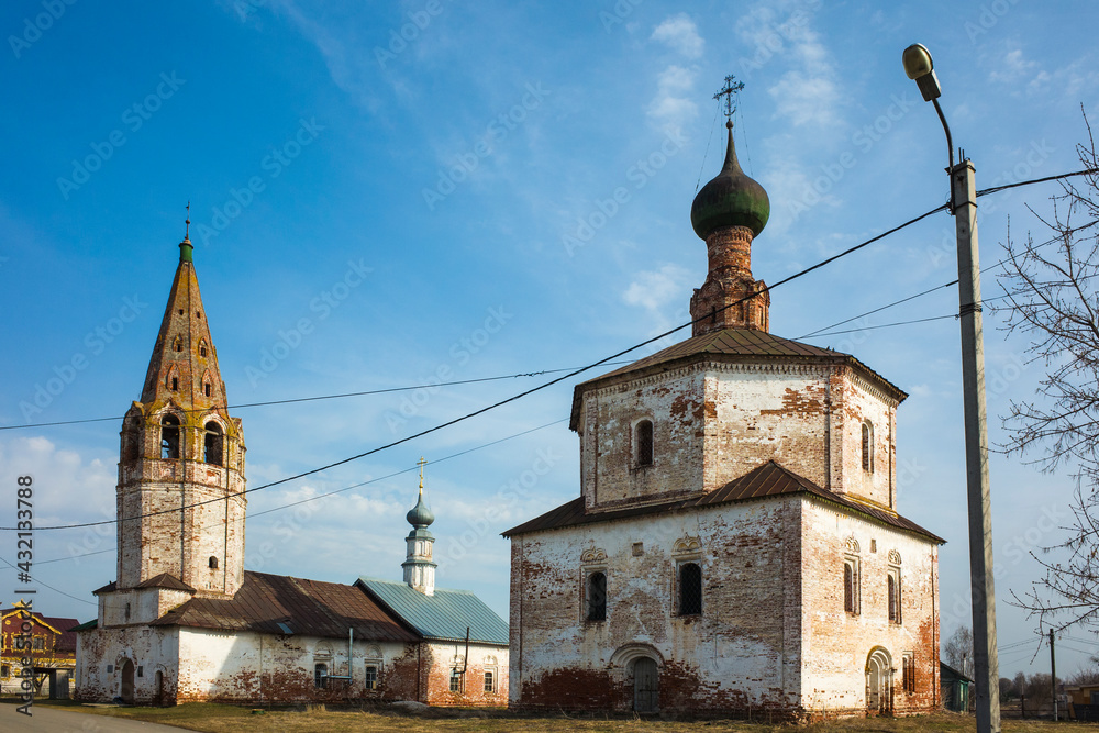 Naklejka premium Old Orthodox Holy Cross church in Suzdal in spring, Time-worn building with crumbling plaster, Part of Golden Ring ancient towns of Russia