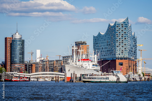 skyline of the hafencity in hamburg with view to the überseebrücke with a famous old freighter and the elbphilharmonie concert hall in the background photo