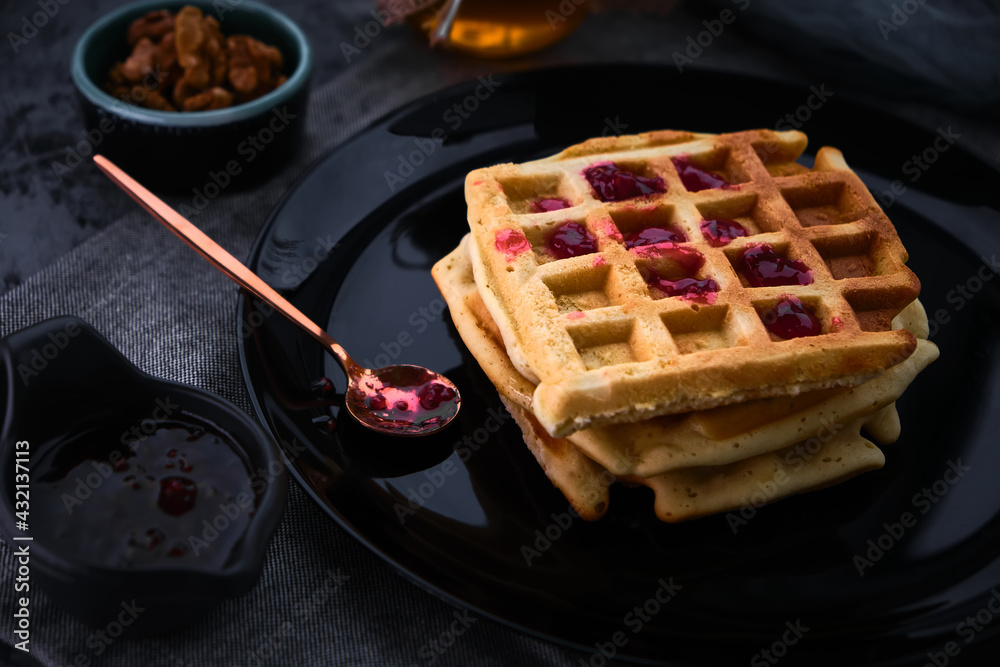 waffles with honey on a dark background waffles with honey on a dark background