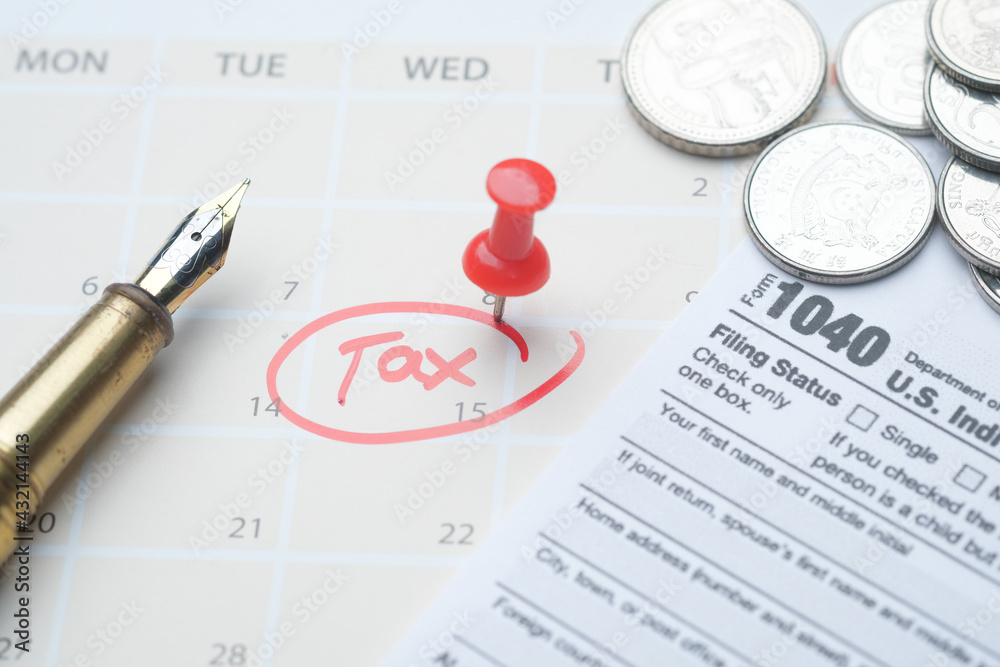 Fototapeta premium tax day concept with red circle on calendar date and tax return on table