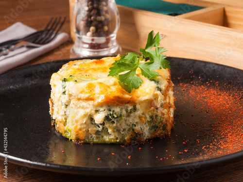 baked broccoli on a black plate in a restaurant. Concept: vegetarian food