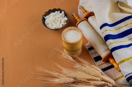 Shavuot is a traditional religious Jewish holiday on torah scroll and tallis photo