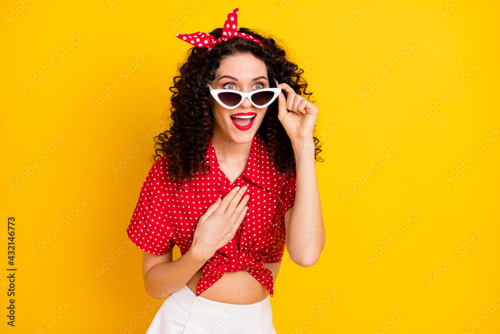 Photo of cute impressed brunette hair lady hand chest wear red top band isolated on yellow color background Photo of cute impressed brunette hair lady hand chest wear red top band isolated on yellow color background