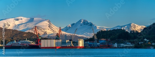 ULSTEINVIK, NORWAY - 2020 MAY 19. Arctic explore cruise vessel at ship yard with white snowdy mountains behind