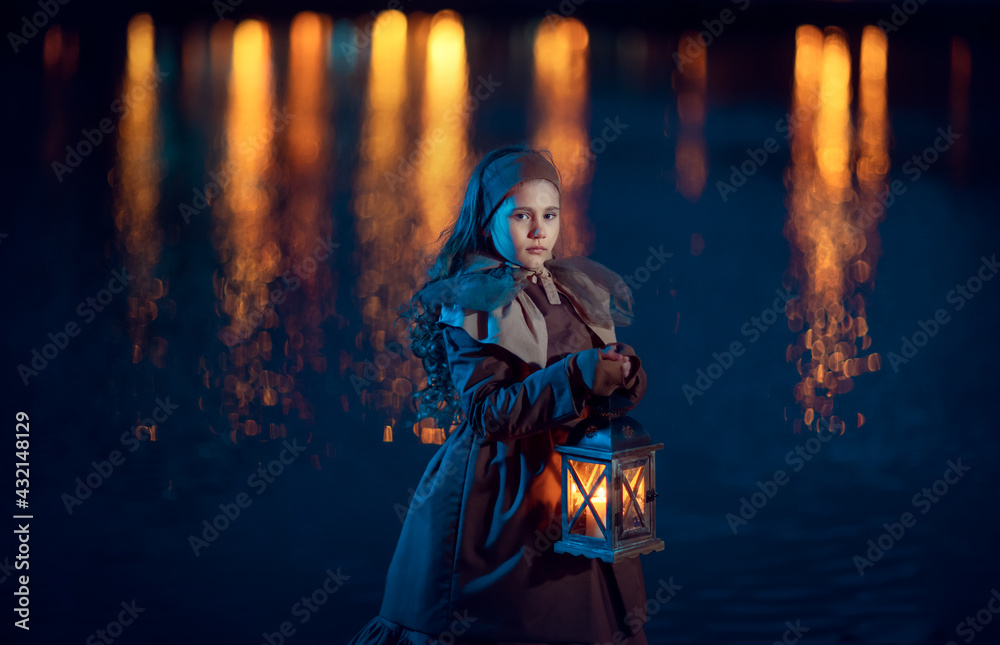 A girl with lantern on the shore of a pond at night
