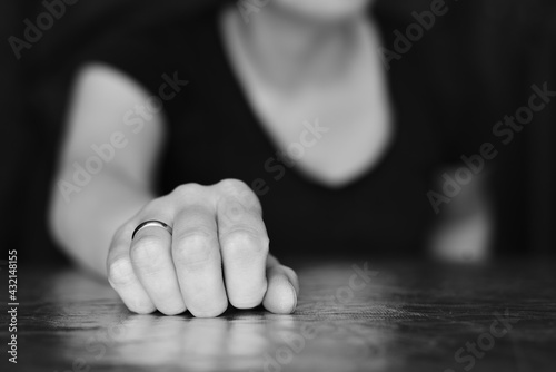 Female hand in focus. Palm with a fancy ring. Black and white portrait of a woman with an outstretched hand. 