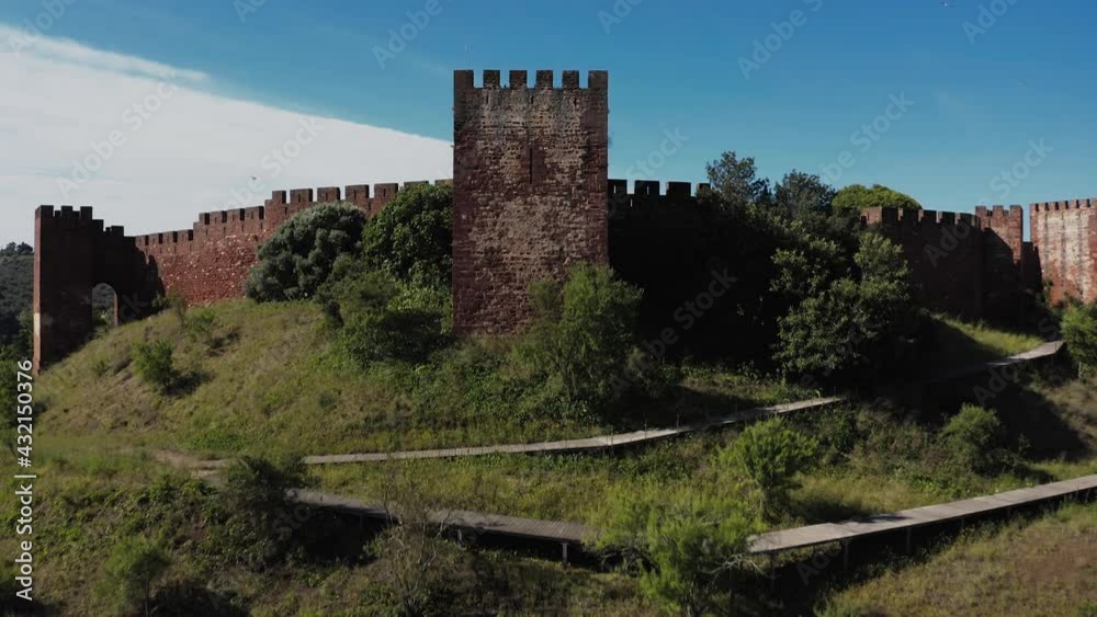 Aerial view of a castle in south Europe. It show's the old structure of the castle on a sunny day with a deep blue sky in the background. Aerial view of a castle in south Europe. It show's the old structure of the castle on a sunny day with a deep blue sky in the background.