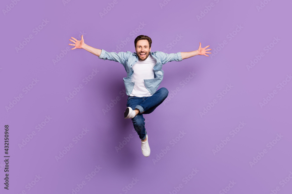 Full body photo of happy positive cheerful young man jump up good mood weekend isolated on violet color background