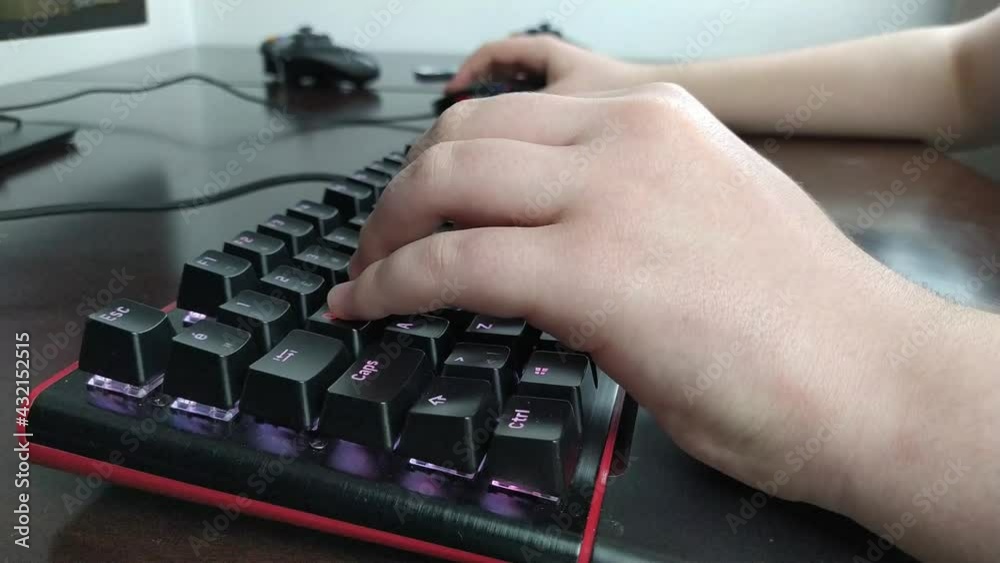 Close-up Hands of Male Player Playing Video Game Using Keyboard Close-up Hands of Male Player Playing Video Game Using Keyboard