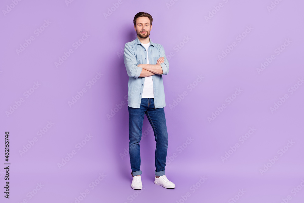 Full length photo of charming serious young woman hold hands folded confident isolated on purple color background Full length photo of charming serious young woman hold hands folded confident isolated on purple color background