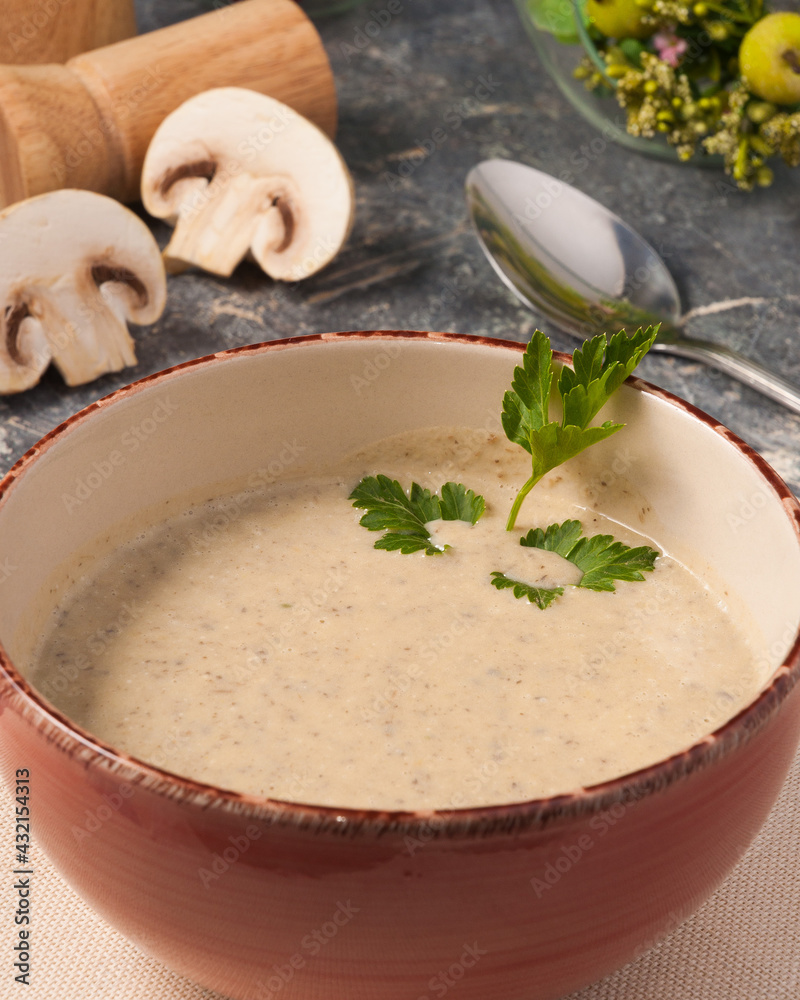 mushroom puree soup decorated with parsley in a bowl mushroom puree soup decorated with parsley in a bowl