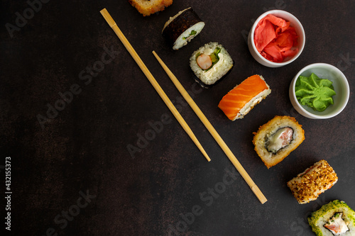 Sushi of different types on a dark background top view, with place for textSushi of different types on a dark background top view, with place for text