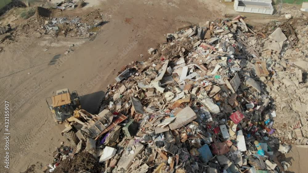 Gota fria - cold drop aftermath extreme weather flood waters disaster 2019 in Orihuela coast Spain. Aerial view excavator disposing flooded heap of landfill and waste, environmental pollution concept Gota fria - cold drop aftermath extreme weather flood waters disaster 2019 in Orihuela coast Spain. Aerial view excavator disposing flooded heap of landfill and waste, environmental pollution concept