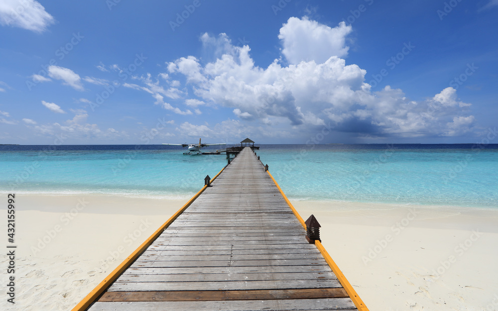 wooden pier at tropical island resort in Maldives