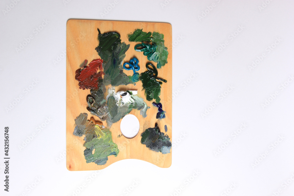Obraz premium The artist's palette. Close-up Of An Art Palette Top view of a colorful palette with colorful mixed colors. oil paints