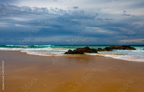 Landscapes Blue sky and waves  breaking on small rock formations and smooth sandy beach on Mid North Coast NSW  Australia