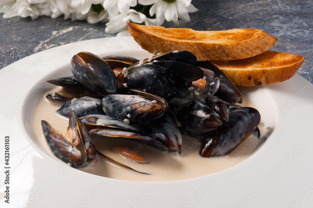 mussels in cream sauce with baguette. Horizontal frame mussels in cream sauce with baguette. Horizontal frame