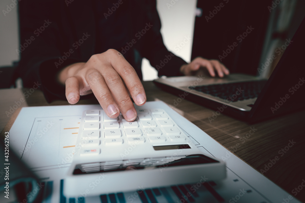 Fototapeta premium bookkeeper or financial inspector hands making report, calculating or checking balance. Home finances, investment, economy, saving money or insurance concept