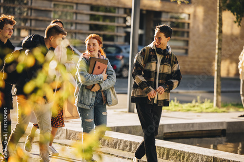 Students walking after class in high school campus photo