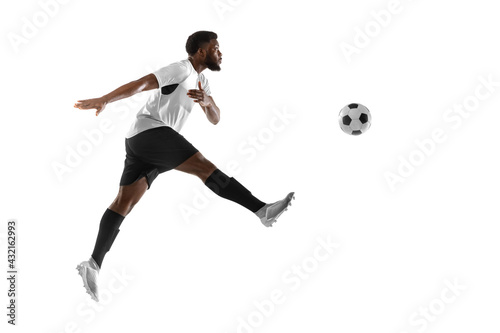 Young African football soccer player training isolated on white background. Concept of sport, movement, energy and dynamic.