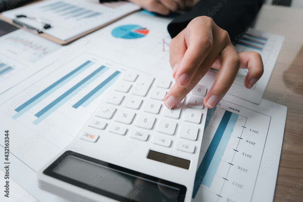 employee accountant man hand press on calculator for make financial report or company's profit monthly at desk , bookkeeper job and work from home concept employee accountant man hand press on calculator for make financial report or company's profit monthly at desk , bookkeeper job and work from home concept