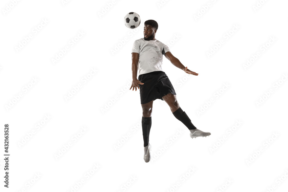Young man soccer player training isolated on white background. Concept of sport, movement, energy and dynamic.