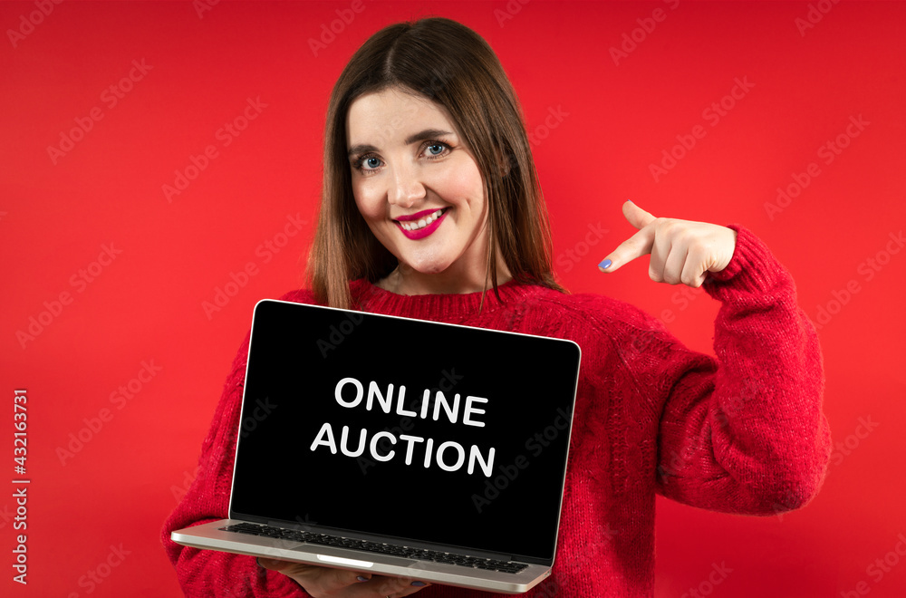Close-up portrait photo of beautiful happy smiling girl with long hair wearing red hoodie holding computer laptop Close-up portrait photo of beautiful happy smiling girl with long hair wearing red hoodie holding computer laptop