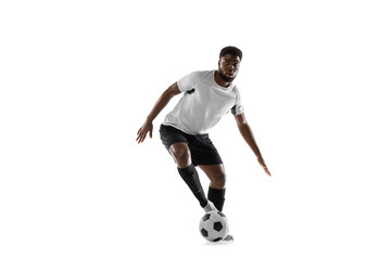 One African man football player training isolated on white background. Concept of sport, movement, energy and dynamic.
