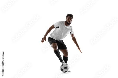 One African man football player training isolated on white background. Concept of sport, movement, energy and dynamic.