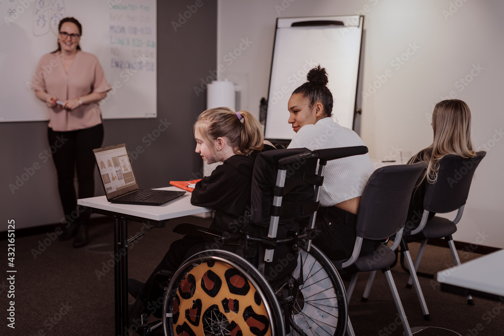 Girl on wheelchair in classroom Girl on wheelchair in classroom