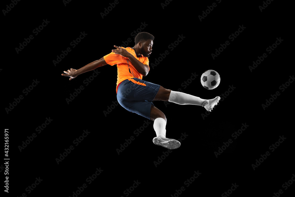 African-american football player playing isolated on black background. Concept of sport.