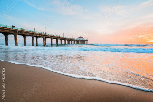 Manhattan beach pier at sunset, orange-pink sky with bright colors, beautiful landscape with ocean and sand photo