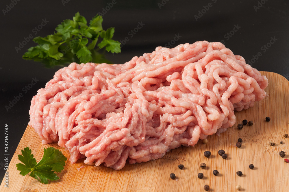 fresh raw minced chicken on a wooden Board