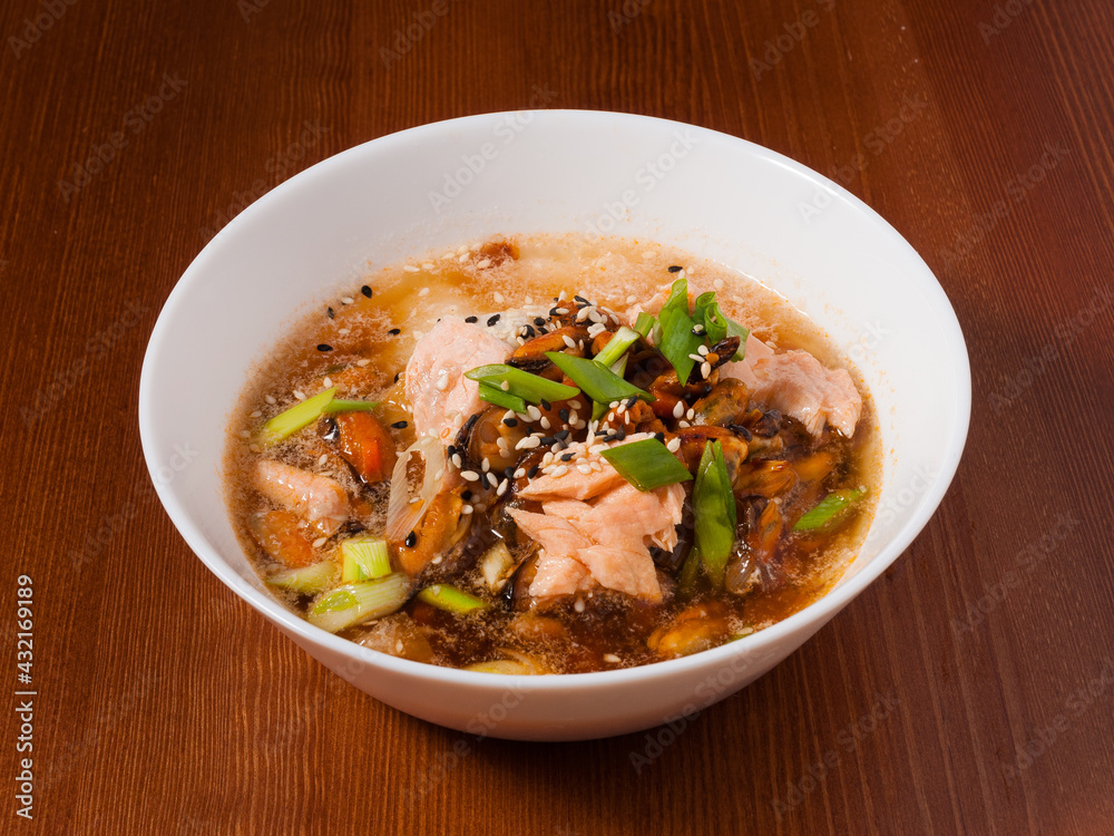Shanghai soup with mussels and fish in a white bowl Shanghai soup with mussels and fish in a white bowl