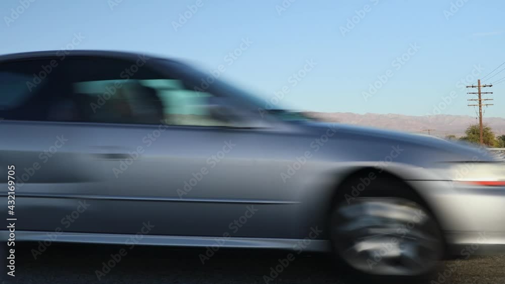 Cars drive in desert landscape on Interstate 10 highway near Indio, California Cars drive in desert landscape on Interstate 10 highway near Indio, California