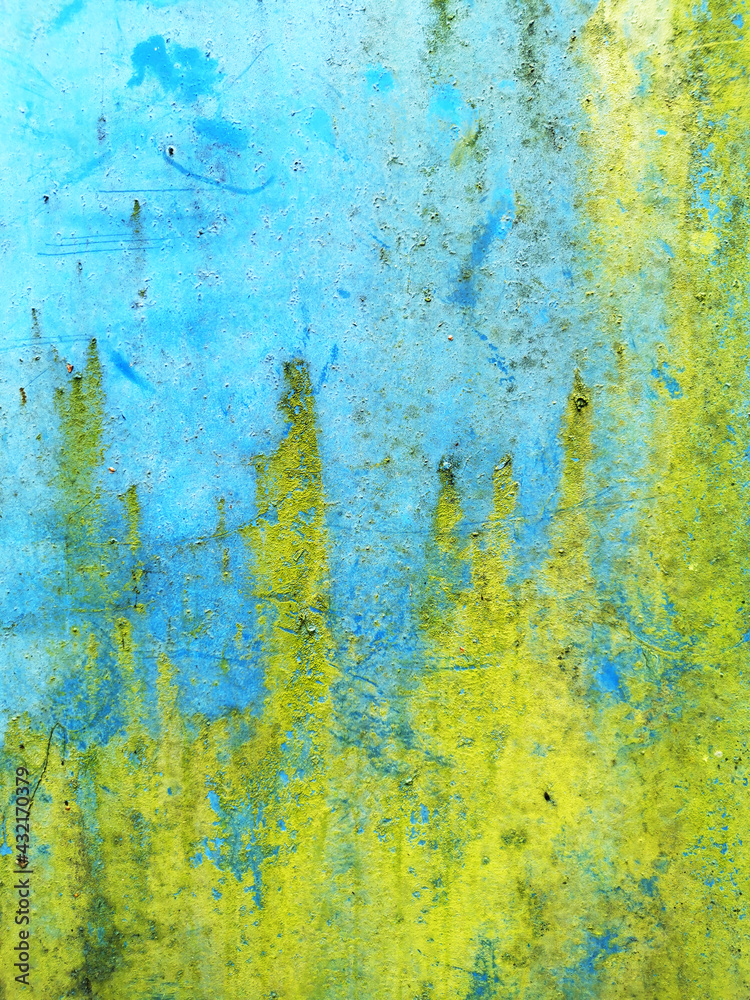 background of a very old metal rusty wall painted with bright blue paint and poisonous green