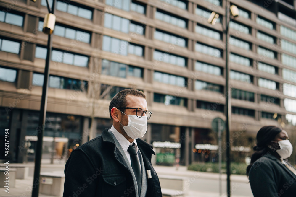 Mature business people in front of building during pandemic Mature business people in front of building during pandemic