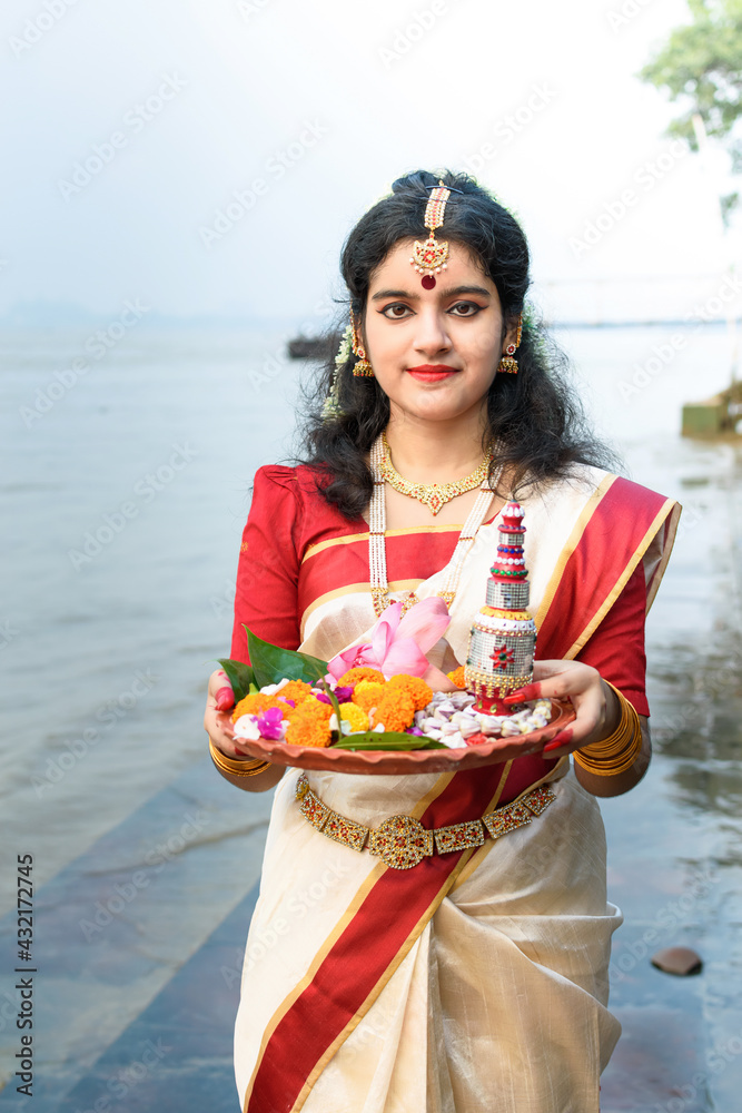 Portrait of beautiful Indian girl in front of ganga river wearing