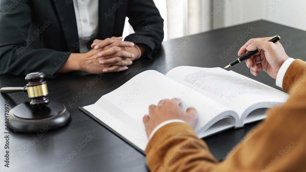 Lawyer preparing to sign a contract and wooden gavel on table justice and law concept. Lawyer preparing to sign a contract and wooden gavel on table justice and law concept.
