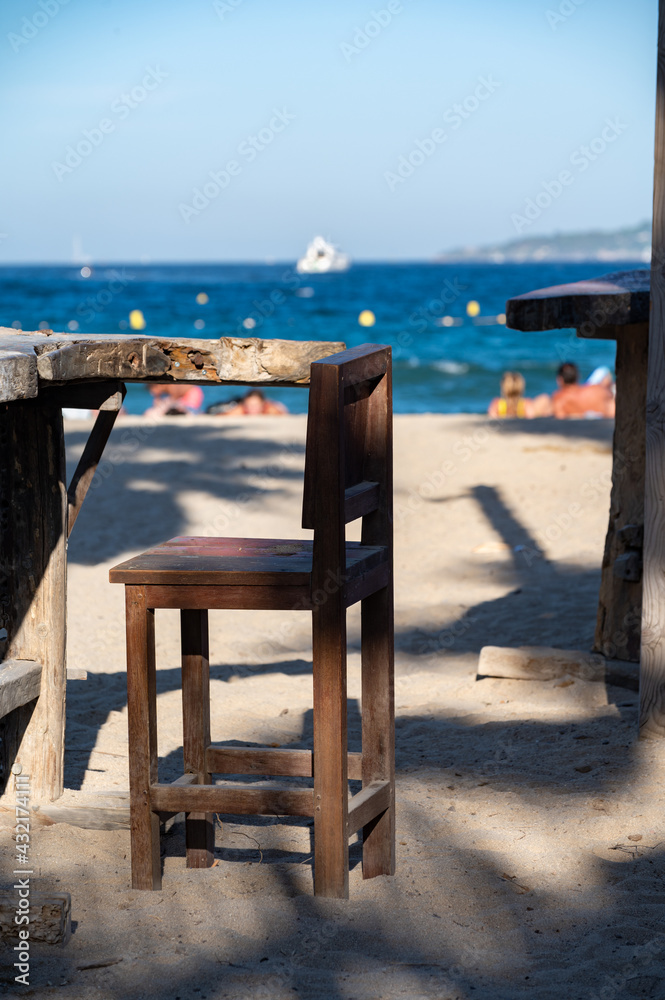 Empty beach cafe with view on blue water of Gulf of Saint-Tropez, French Riviera, France