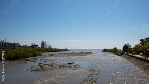 The river flows into the sea. Meeting of freshwater and salt water. The concept - everything tends to become big