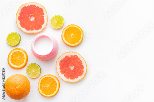 Cream and citrus fruits . Skin care. Citrus-based cream. White background.