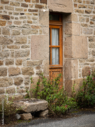 Brown wooden door of an old stone house