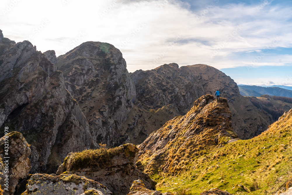 Obraz premium A young man walking on the top of the mountain of Aiako Harria or Peñas de Aya in the town of Oiartzun, Guipúzcoa. Basque Country