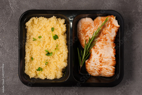 bulgur and pork chop in a container. Concept: ready food delivery
