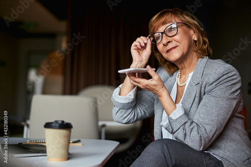 Portrait of businesswoman that listening to voice message