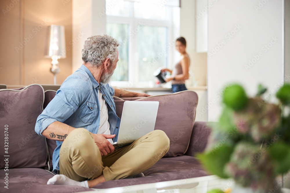 Kind grey-haired man turning head to his partner Kind grey-haired man turning head to his partner